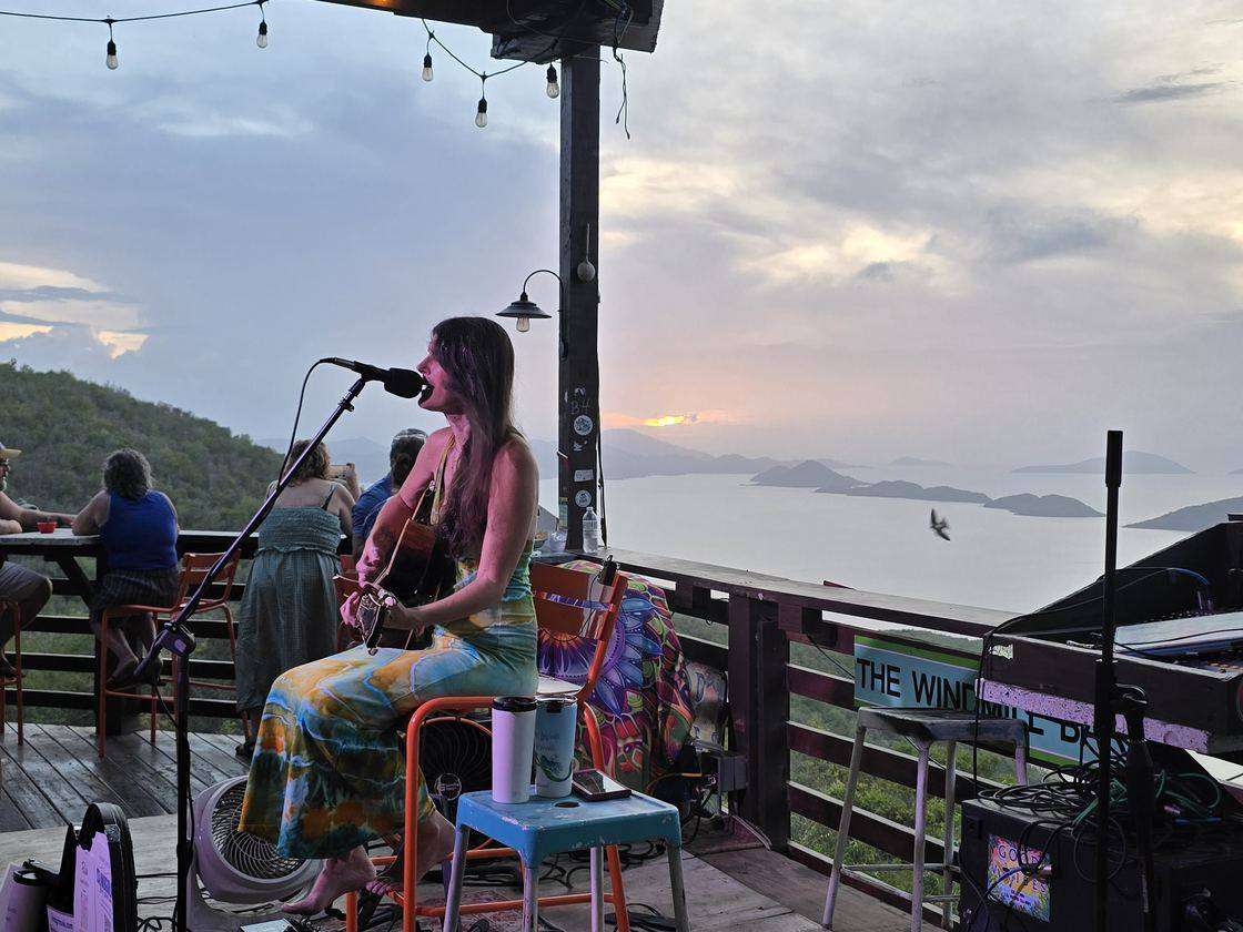 Live music at sunset on the deck at the Windmill Bar, overlooking the North Shore islands, St. John